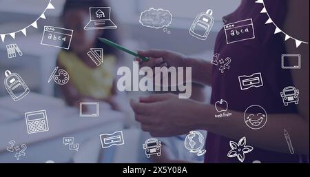 Image of school icons over hands of diverse female teacher explaining to pupils in class Stock Photo