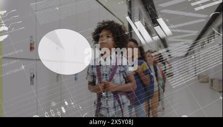 Image of data processing over happy diverse schoolchildren standing in a row in school corridor Stock Photo