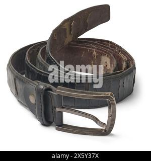 old used men's synthetic leather belt with metal buckle isolated white background, black dirty cracked and peeling surface due to regular use Stock Photo