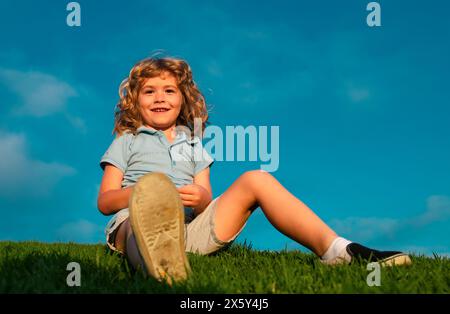 Kid on nature summer field. Active family leisure with kids. Child fun outdoors. Stock Photo