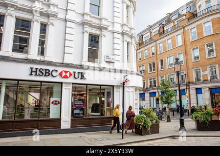 Branch of british bank HSBC UK in Covent Garden London, bank logo visible, two women walk past the bank branch,London,England,UK Stock Photo