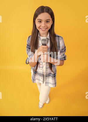 happy teen girl blogger interviewing with microphone. young interviewer girl making interview. teen school interview. interview online. teen Stock Photo