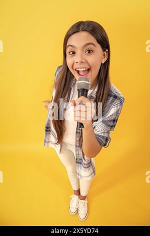 teen interviewer of gen z. interviewing for her blog. amazed teen girl blogger interviewing with microphone. young interviewer girl making interview. Stock Photo