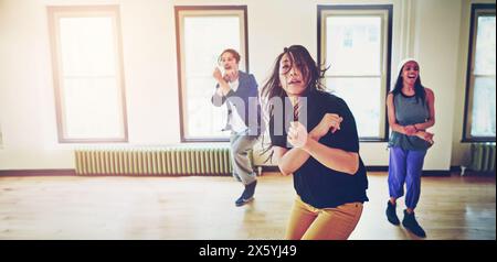 Indoor, hip hop and group of dancers in action, breakdance and performance together with move. Inside, practice or freestyle of talented people with Stock Photo