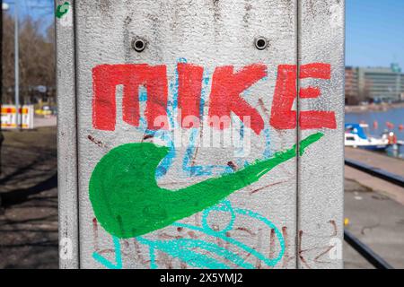 Mike resembling Nike logo painted on electric street cabinet in Merihaka district of Helsinki, Finland Stock Photo