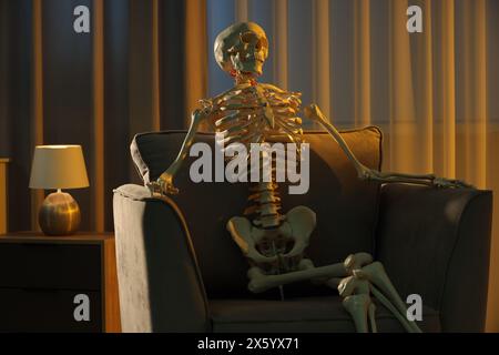 Waiting concept. Human skeleton sitting in armchair indoors Stock Photo