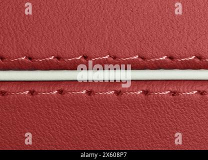 Car red leather interior. Part of perforated leather door handle details. Red Perforated leather texture background. Texture, artificial leather with Stock Photo