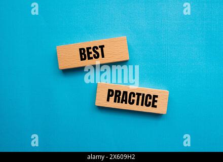 Best practice words written on wooden blocks with blue background. Conceptual best practice symbol. Copy space. Stock Photo