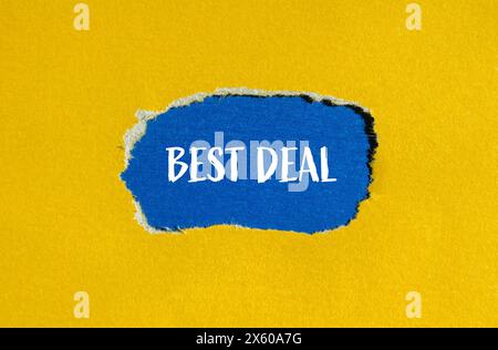 Best deal words written on ripped yellow paper with blue background. Conceptual best deal symbol. Copy space. Stock Photo
