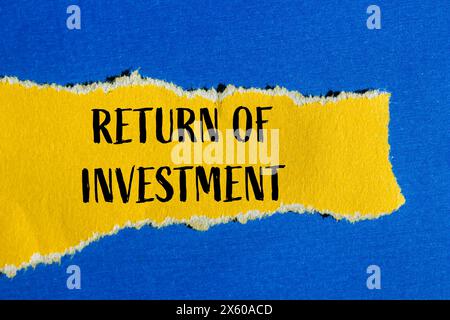 Return of investment words written on ripped yellow paper with blue background. Conceptual return of investment and business symbol. Copy space. Stock Photo