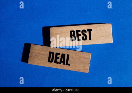 Best deal words written on wooden blocks with blue background. Conceptual best deal symbol. Copy space. Stock Photo