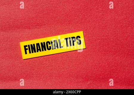 Financial tips words written on yellow paper sticker with red background. Conceptual financial tips symbol. Copy space. Stock Photo