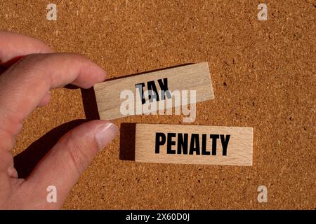 Tax penalty written on wooden blocks with brown background. Conceptual tax penalty symbol. Copy space. Stock Photo