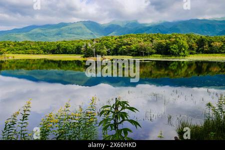 The Shiretoko mountain ranges and their reflections along the shores of Lake Niko in Shiretoko Goko (Five Lakes) National Park, Hokkaido, Japan. Stock Photo