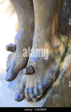 Feet of Jesus Christ crucified. Crucifixion, crucifixion of Jesus of Nazareth, torture of the cross, gospels, Christians, Christian religion. Beynac, Stock Photo