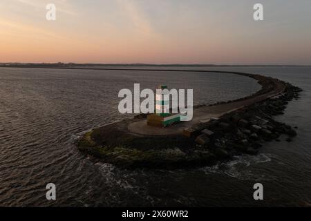 Green lighthouse, end of south pier, IJmuiden, Netherlands. Stock Photo