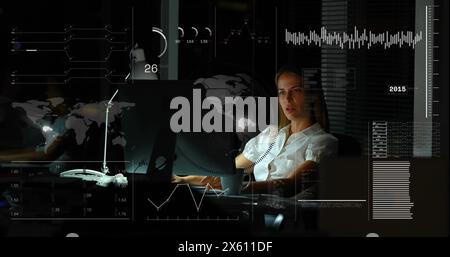 Image of infographic interface and focused caucasian businesswoman working over computer Stock Photo