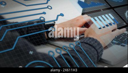 Image of graphs, circles and circuit board pattern over caucasian man working on laptop Stock Photo