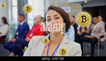 Image of bitcoin icons over diverse business people at conference Stock Photo