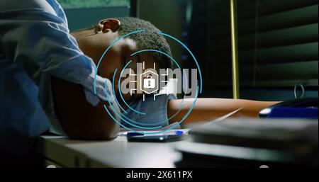 Image of circle with lock icon over african american businesswoman sleeping on desk in office Stock Photo