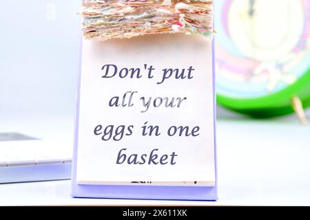 Don't put all your eggs in one basket text the inscription on the calendar with tear-off leaves Stock Photo