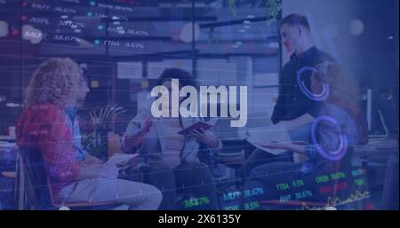 Image of financial data processing over diverse businesspeople in office Stock Photo