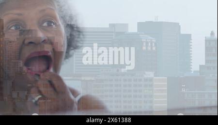 Image of senior african american woman doing make up over cityscape Stock Photo