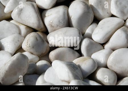 Background - white tumbled marble stones on the coast of a unique sea coast Stock Photo