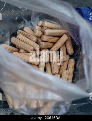 furniture pegs in a bag on the floor at the workplace Stock Photo