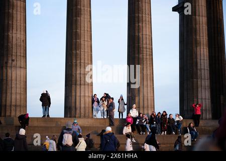 Edinburgh Scotland: 13th Feb 2024: Tourists enjoying the Carlton Hill lookout point at sunset. Edinburgh city skyline Stock Photo