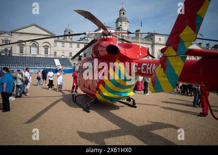 Crowds gather around London's Air Ambulance after landing on Horse Guards Parade in Central London. Stock Photo