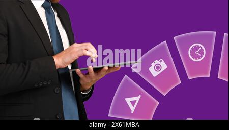 Image of multiple icons over midsection of businessman scrolling on digital tablet Stock Photo