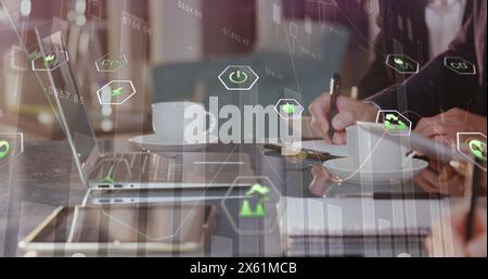 Image of eco icons and data processing over diverse business people in office Stock Photo