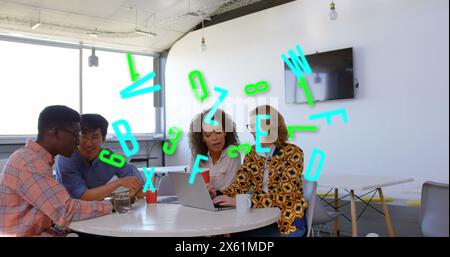 Image of letters and numbers processing over diverse business people in office Stock Photo