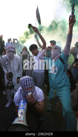 Protesters gather around a flare in Paris, France on October 24, 2026 ...