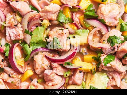 Close-up of an appetizing ceviche dish featuring fresh seafood, avocado, mango, and cilantro garnish. Stock Photo