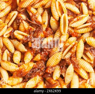 Close-up of delicious beef ragu sauce over cooked gnocchi pasta, representing italian cuisine. Stock Photo