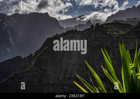Sharp peaks of Santo Antão slice through a dramatic cloudscape, offering a stunning display of Cape Verde's rugged natural beauty, perfect for intrepi Stock Photo