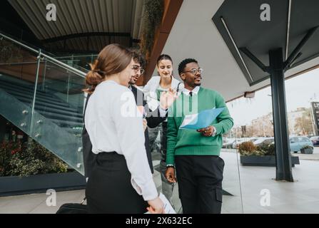 Diverse startup team holding an informal outdoor business meeting Stock Photo