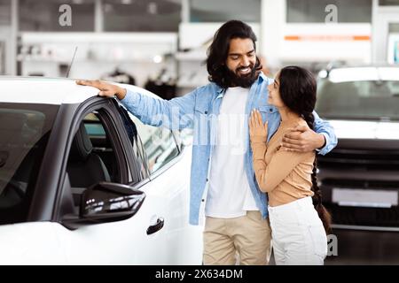 Indian Man and Woman Standing Next to Car Stock Photo