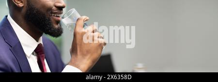 Unrecognizable black businessman drinking water, copy space Stock Photo