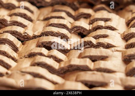 Crumpled cutted paper filler for parcels. Brown protective material close up Stock Photo