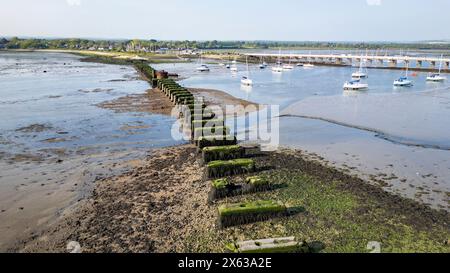 Remains of old railway bridge from Langstone (top of picture) to Hayling Island in Hampshire, UK Stock Photo