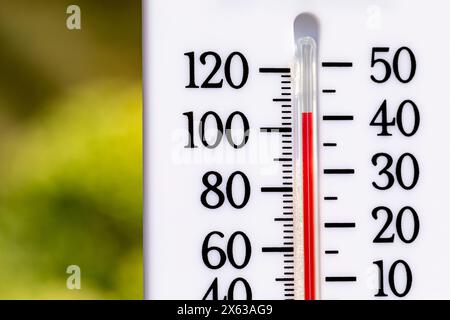 Outdoor thermometer in the sun during heatwave. Hot weather, high temperature and heat warning concept. Stock Photo