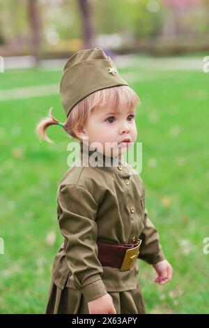 Adorable baby girl in Soviet military uniform Stock Photo