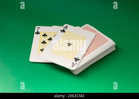 Playing cards for poker and gambling, isolated on green background. Stock Photo