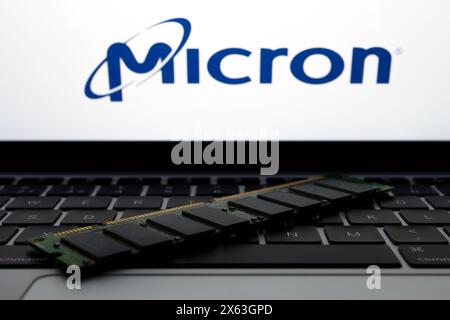 MICRON logo seen on the screen of laptop and RAM memory in front of it. Micron Technology. is an American producer of computer memory and data storage Stock Photo