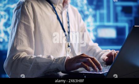 Productive engineer in high tech establishment uses artificial intelligence computing simulating human brain. Tech savvy admin running operations on laptop with AI machine learning algorithms close up Stock Photo