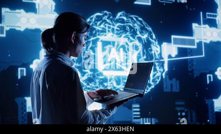 System admin in data center running programming scripts on laptop, solving tasks. Certified developer manipulating lines of code for artificial intelligence applications development Stock Photo
