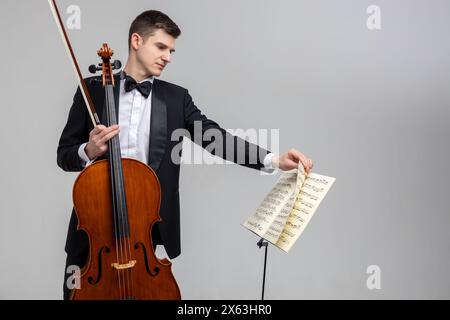 Young male musician performing with cello and music note Stock Photo